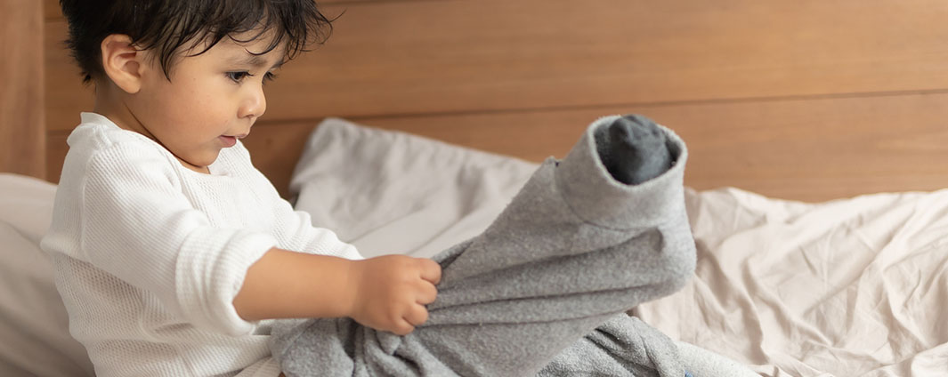 Child trying to put on pants