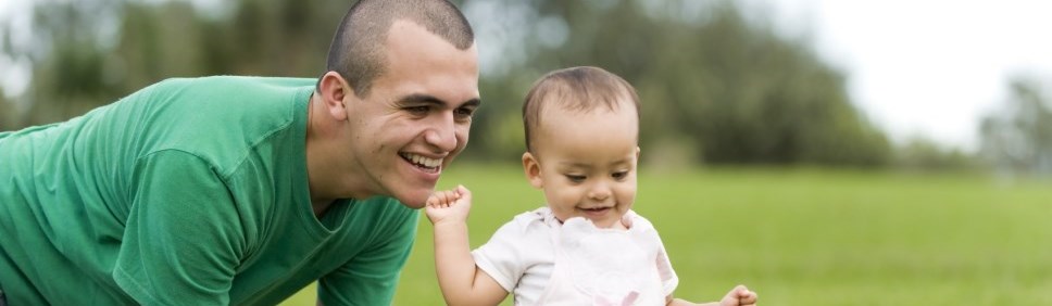 father playing outside with little girl 