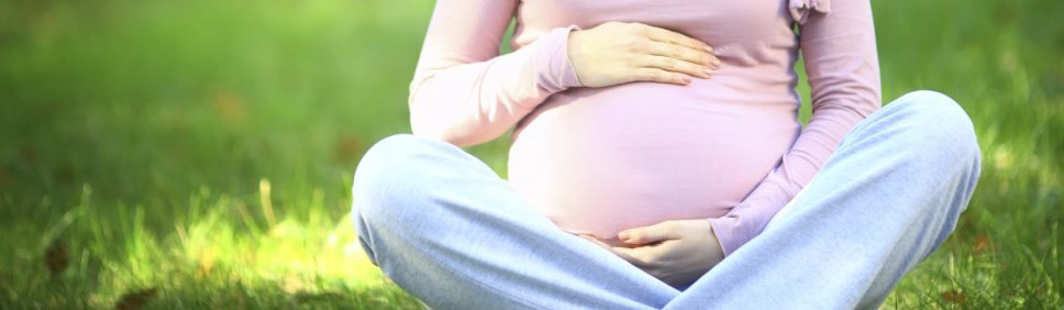 woman holding her pregnant belly 