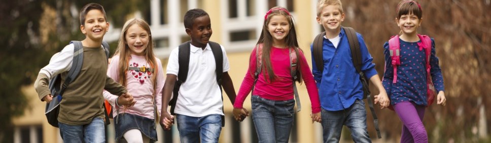 group of children walking to school hand in hand