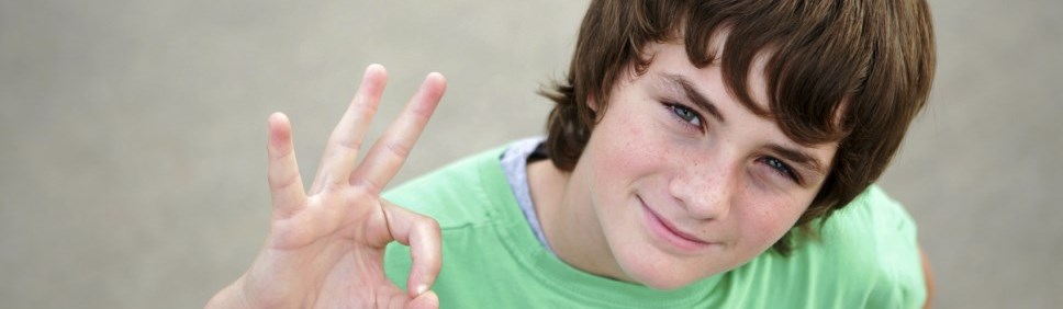 boy giving okay signal with hand