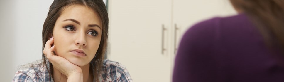 teenage girl staring blankly